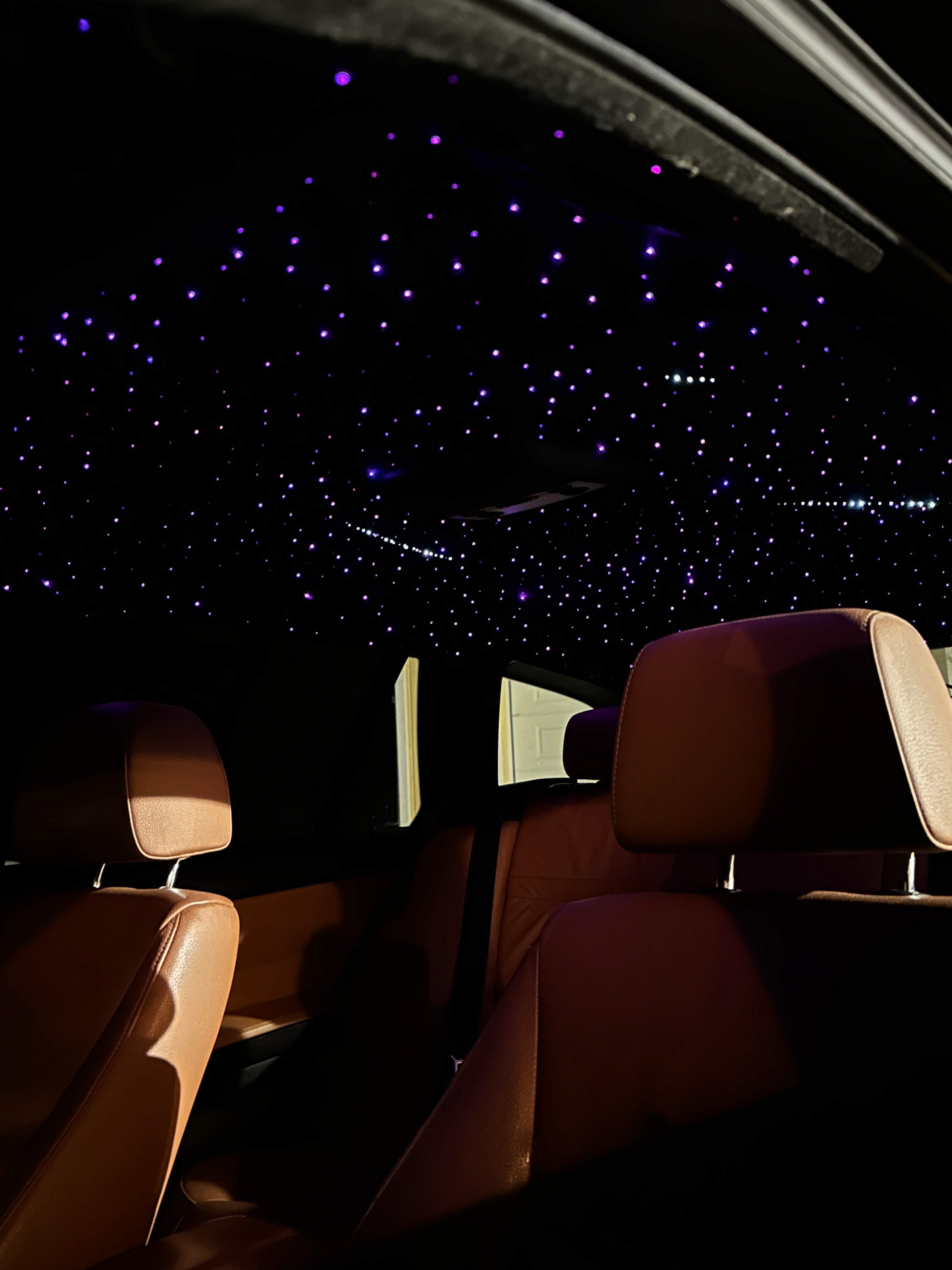 Car interior with a starry night sky view through the window
