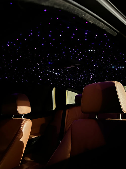 Car interior with a starry night sky view through the window