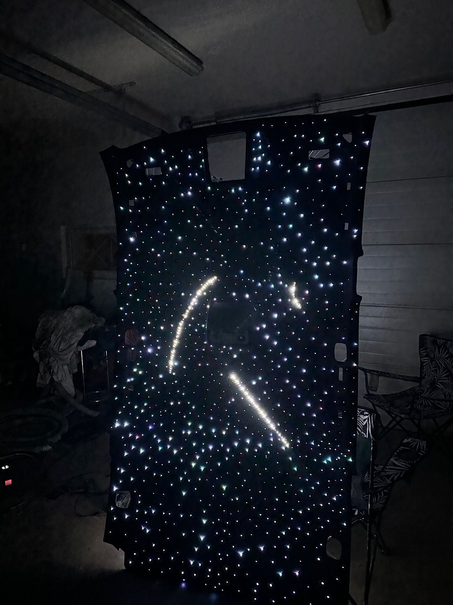 Star-patterned fabric with a smiley face design on a dark background